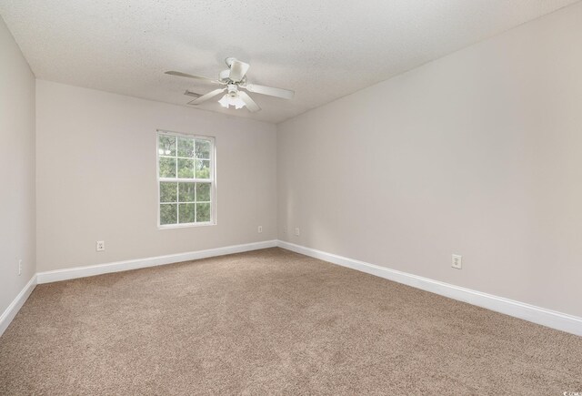 spare room with carpet, a textured ceiling, and ceiling fan