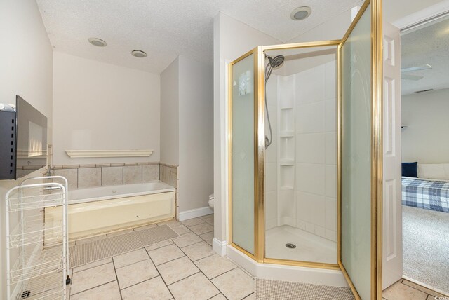 bathroom with toilet, tile patterned floors, a textured ceiling, and plus walk in shower