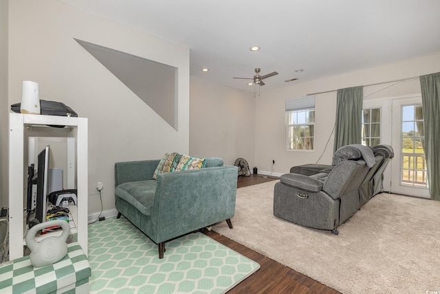 living room featuring ceiling fan and wood-type flooring