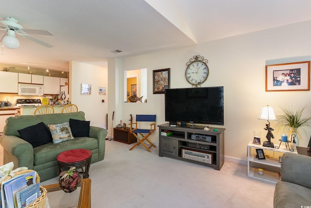 living area with baseboards, light colored carpet, ceiling fan, and visible vents