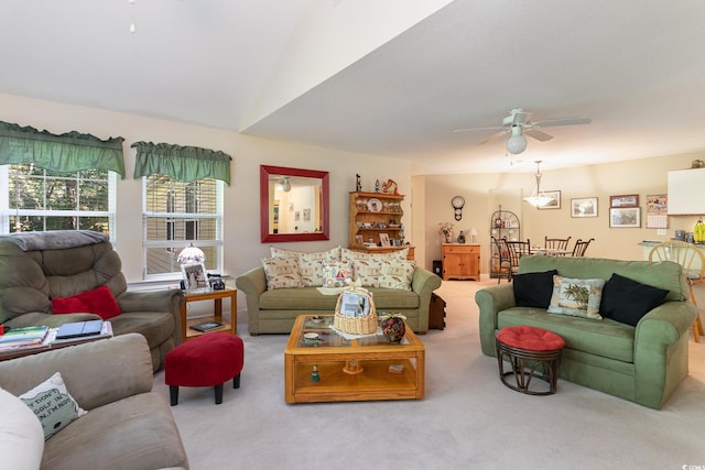 carpeted living room featuring ceiling fan and vaulted ceiling