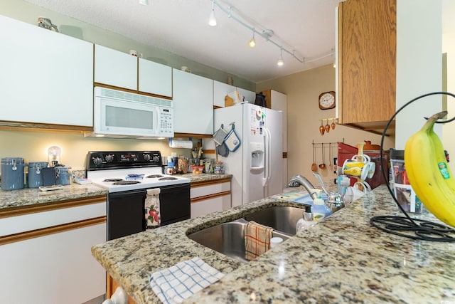 kitchen featuring light stone counters, white cabinets, white appliances, a textured ceiling, and sink