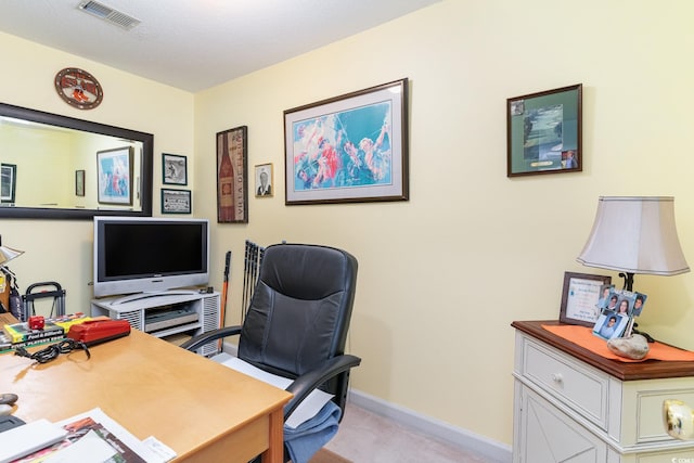 office featuring light carpet, baseboards, and visible vents