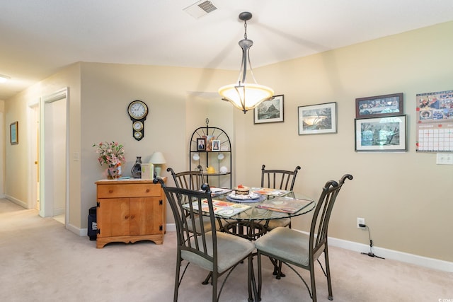 dining room featuring visible vents, baseboards, and light colored carpet