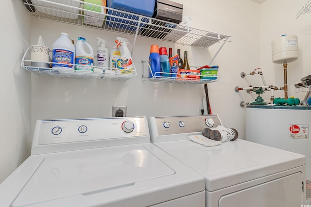 laundry area featuring water heater and washer and dryer