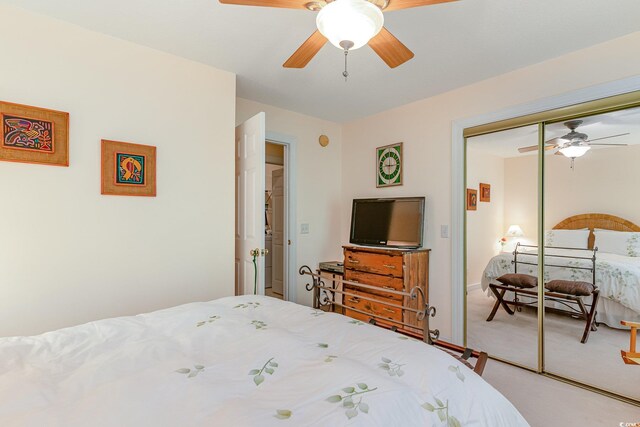 carpeted bedroom featuring ceiling fan and a closet