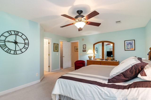 bedroom featuring visible vents, light colored carpet, baseboards, and ceiling fan