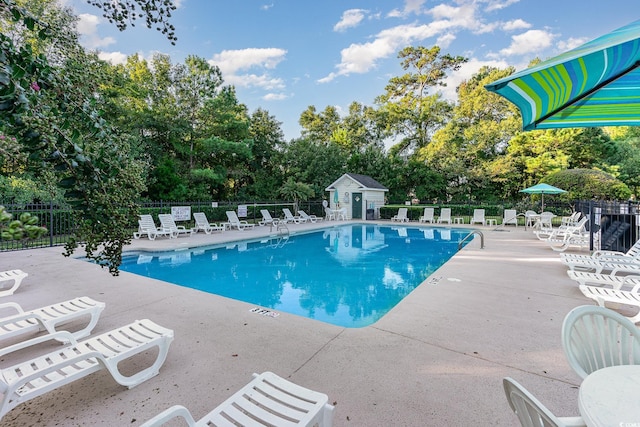 view of pool featuring an outdoor structure and a patio