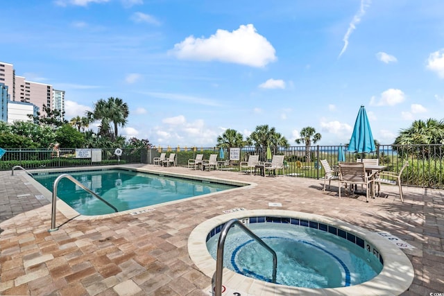 view of swimming pool with a patio and a community hot tub