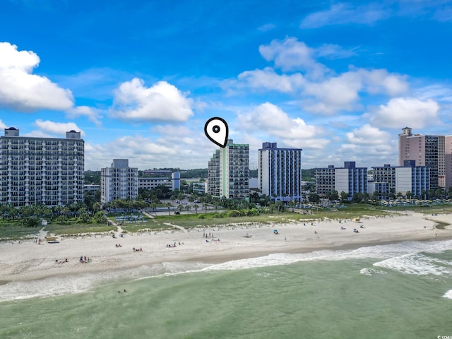 aerial view with a water view and a beach view