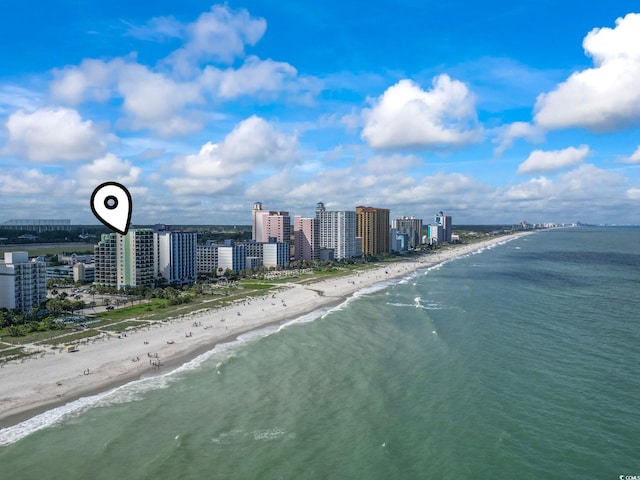 birds eye view of property with a beach view and a water view