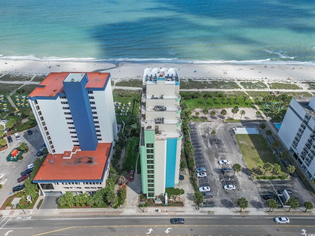 bird's eye view with a water view and a beach view