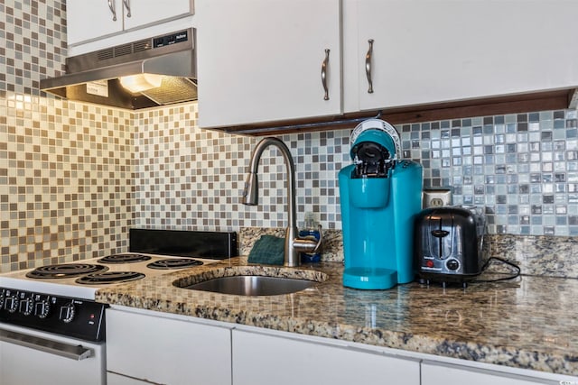 kitchen featuring white cabinets, stone countertops, extractor fan, white range with electric cooktop, and decorative backsplash