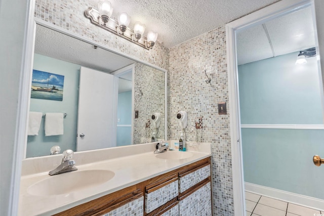 bathroom featuring tile patterned flooring, a textured ceiling, and vanity