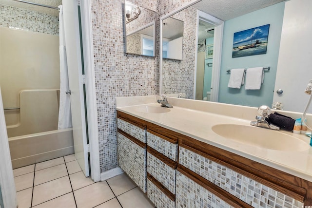 bathroom featuring a textured ceiling, tile patterned flooring, vanity, and shower / bathtub combination with curtain