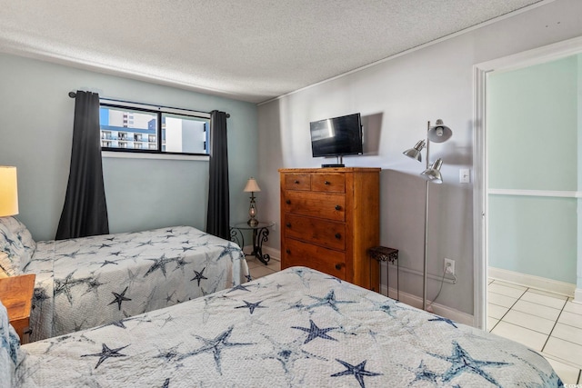 tiled bedroom with a textured ceiling