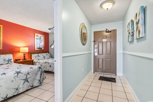 tiled foyer with a textured ceiling