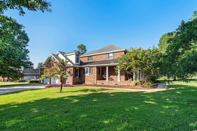 view of front of home with a front yard and a garage