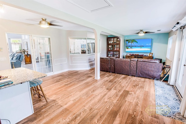 interior space with ceiling fan and light hardwood / wood-style flooring