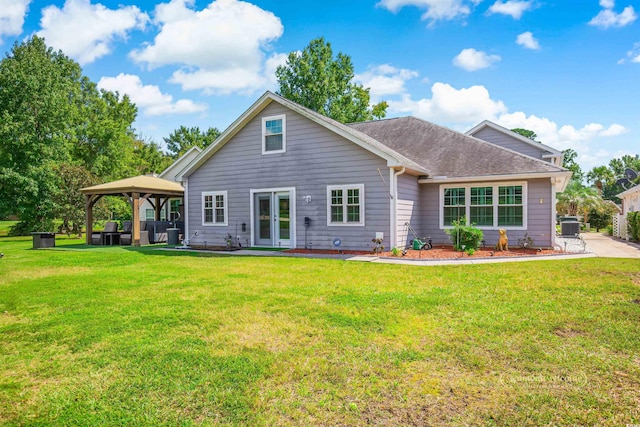 rear view of property with french doors, a patio area, a gazebo, and a lawn