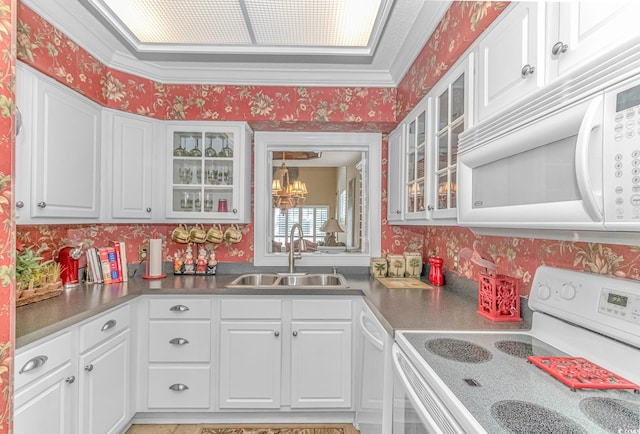 kitchen with sink, white appliances, and white cabinetry