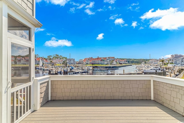 wooden terrace featuring a water view