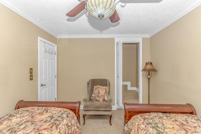 bedroom featuring ornamental molding, ceiling fan, carpet flooring, and a textured ceiling