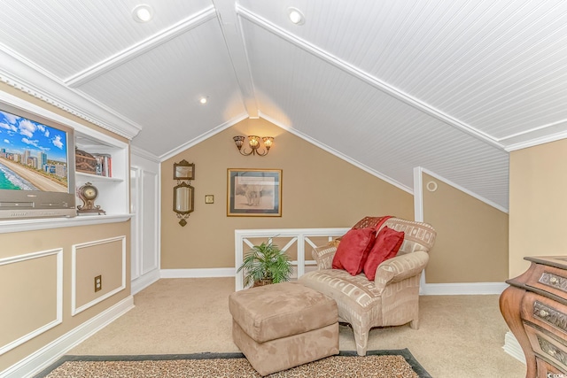 sitting room with wood ceiling, vaulted ceiling, built in shelves, ornamental molding, and light colored carpet