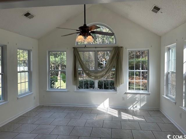 unfurnished sunroom with ceiling fan and lofted ceiling