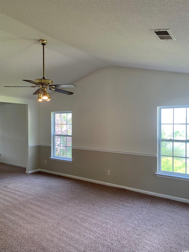 spare room featuring carpet flooring, ceiling fan, a textured ceiling, and vaulted ceiling