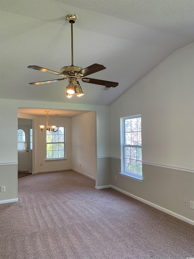 unfurnished room featuring carpet, ceiling fan with notable chandelier, and lofted ceiling