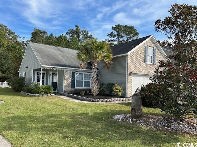 view of front of property featuring a garage and a front lawn