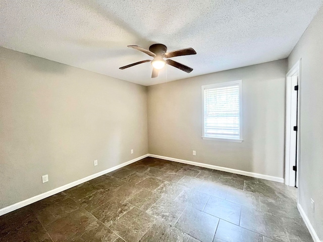 spare room featuring a textured ceiling and ceiling fan