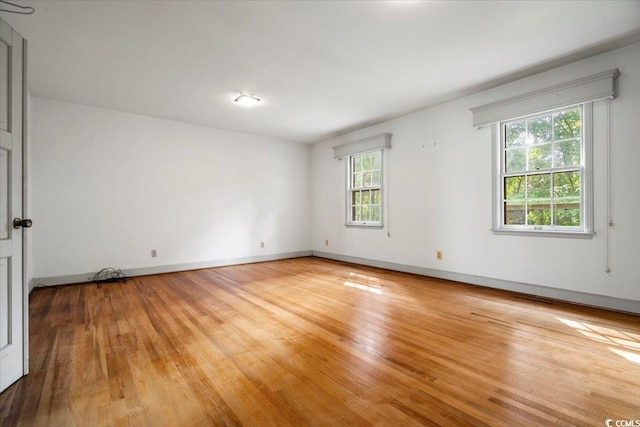 unfurnished room with light wood-type flooring