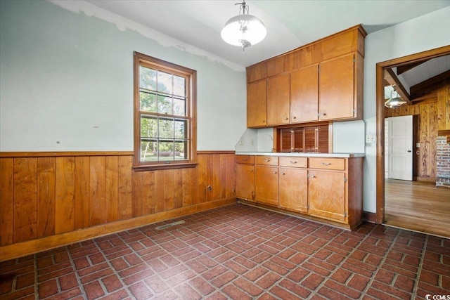 kitchen with pendant lighting and wood walls