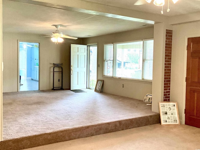 carpeted empty room with ceiling fan