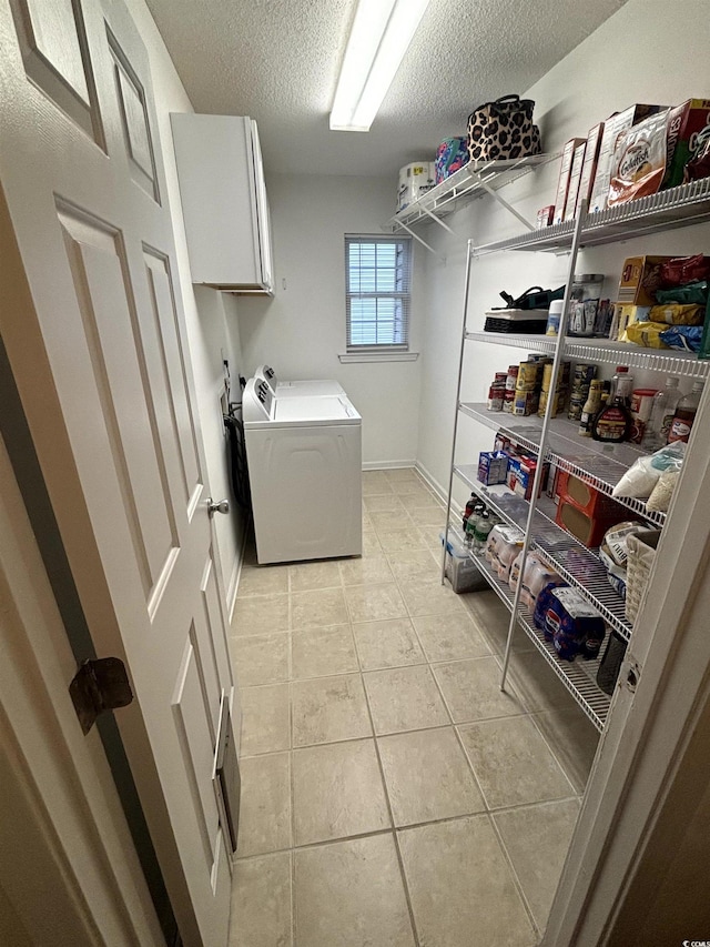 2108 Kirkland Dr, Conway, SC 29526 - laundry room with washer / clothes dryer, cabinet space, a textured ceiling, light tile patterned floors, and baseboards