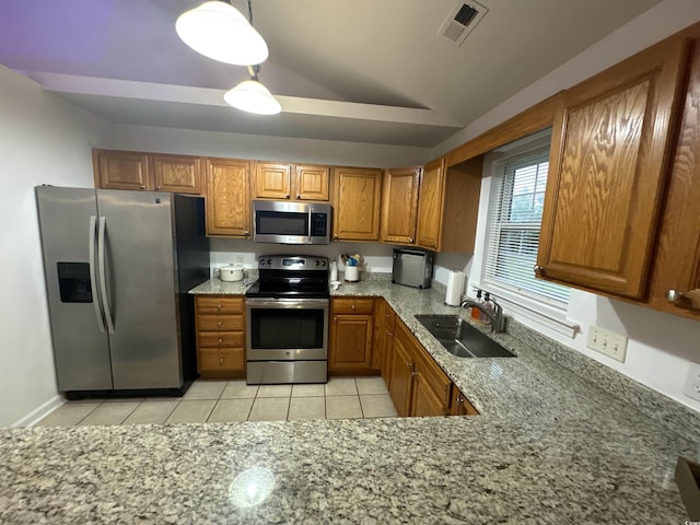 2108 Kirkland Dr, Conway, SC 29526 - kitchen with brown cabinets, a sink, stainless steel appliances, light stone countertops, and lofted ceiling