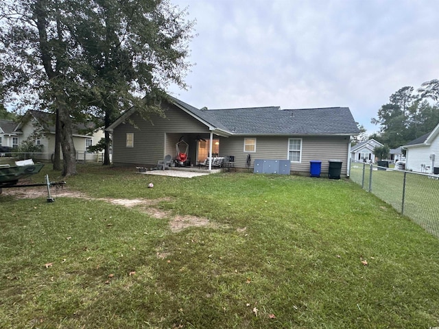 2108 Kirkland Dr, Conway, SC 29526 - rear view of house with a lawn, a patio area, roof with shingles, and a fenced backyard