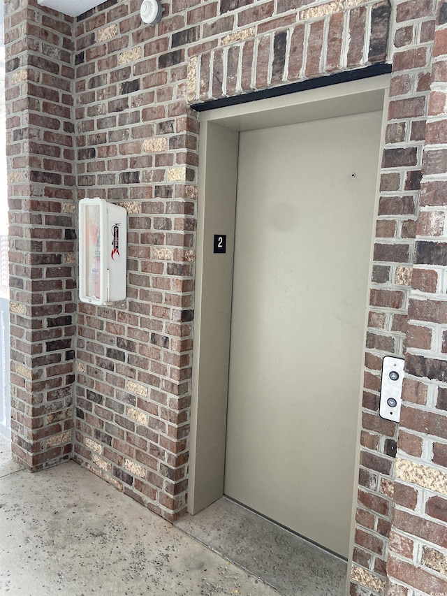 4870 Luster Leaf Cir Unit 401, Myrtle Beach, SC 29577 - view of exterior entry with brick siding and elevator