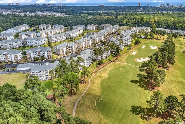 4870 Luster Leaf Cir Unit 401, Myrtle Beach, SC 29577 - view of property location with apartment complex / building, a golf club, a large body of water, and a tree filled landscape