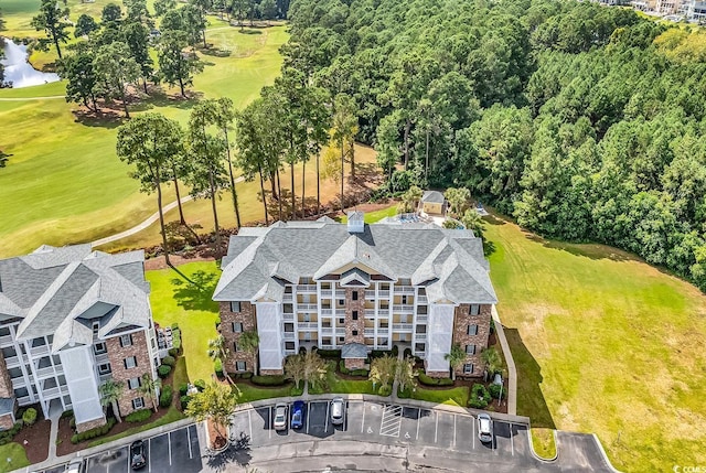 4870 Luster Leaf Cir Unit 401, Myrtle Beach, SC 29577 - drone / aerial view of a golf course, a nearby body of water, and apartment complex