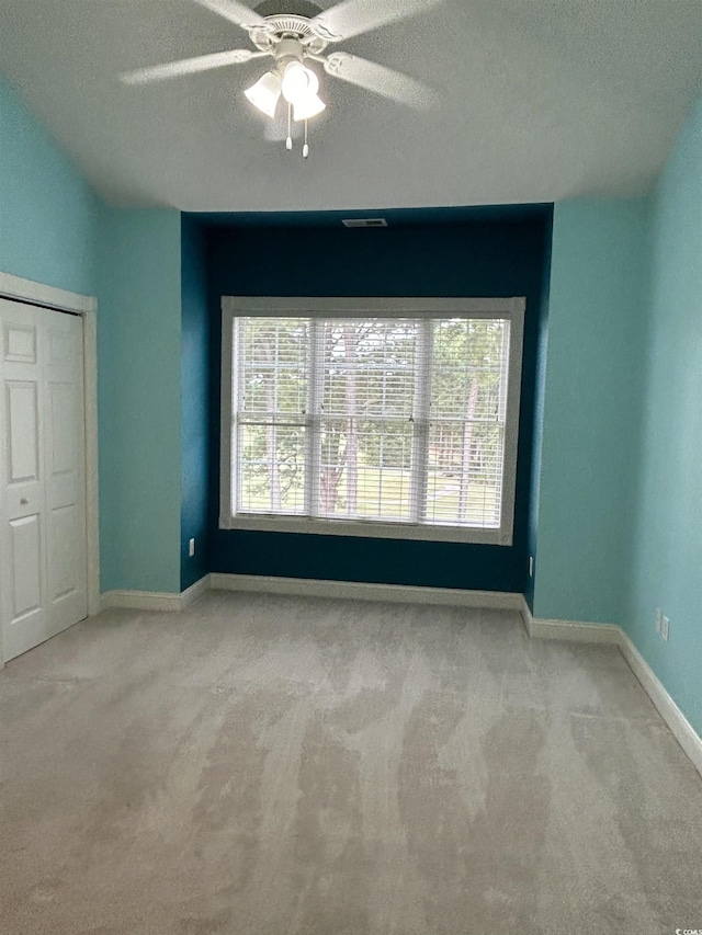 4870 Luster Leaf Cir Unit 401, Myrtle Beach, SC 29577 - unfurnished bedroom with carpet, a textured ceiling, baseboards, and ceiling fan