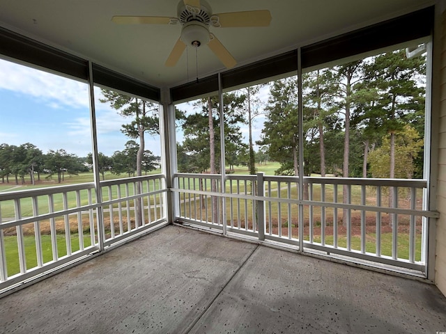 unfurnished sunroom featuring ceiling fan and a healthy amount of sunlight