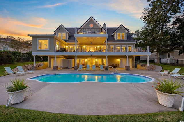 1324 Harbour Watch SW, Calabash, NC 28467 - rear view of house featuring a balcony, a patio, an outdoor pool, and a chimney