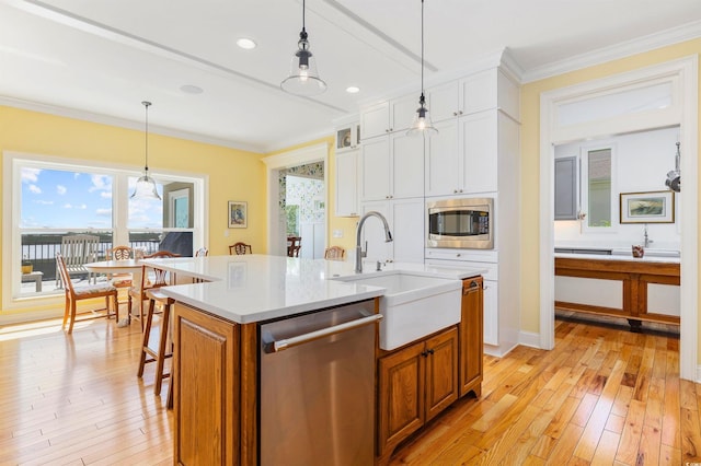 1324 Harbour Watch SW, Calabash, NC 28467 - kitchen with stainless steel appliances, a sink, crown molding, light countertops, and light wood finished floors