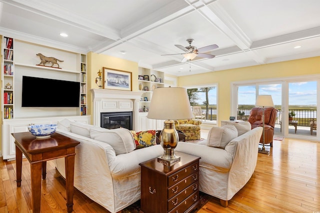 living room featuring coffered ceiling, ceiling fan, and light hardwood / wood-style flooring