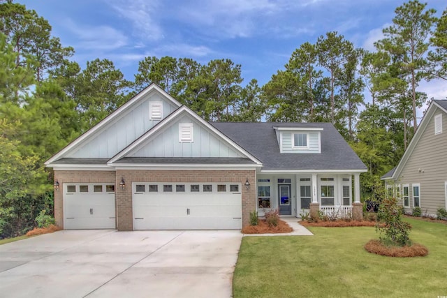 craftsman-style home with a garage, a porch, and a front lawn