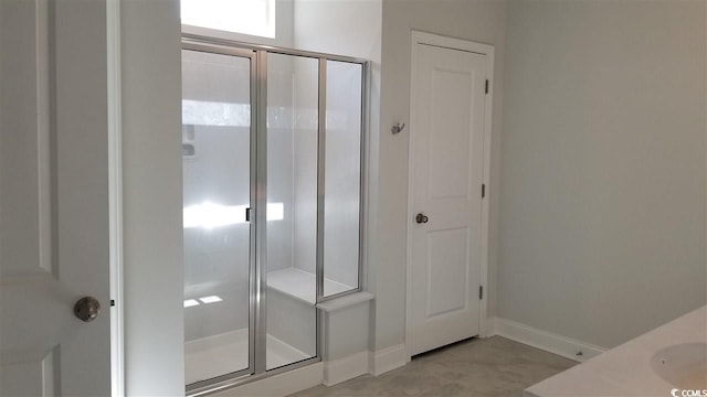 bathroom featuring a shower with door