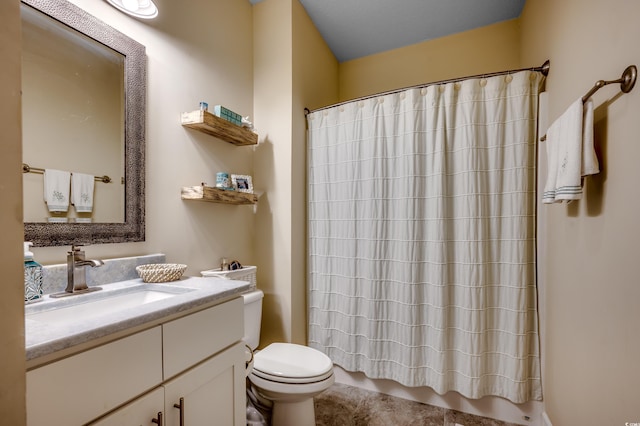 bathroom featuring a shower with curtain, vanity, and toilet